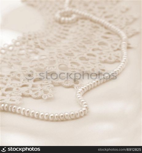 Smooth elegant golden silk or satin with pearls and lace can use as wedding background. In Sepia toned. Retro style