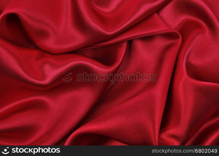 Smooth elegant red silk or satin luxury cloth texture can use as abstract background. Luxurious valentines day background design