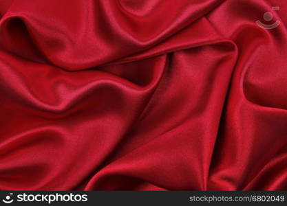 Smooth elegant red silk or satin luxury cloth texture can use as abstract background. Luxurious valentines day background design