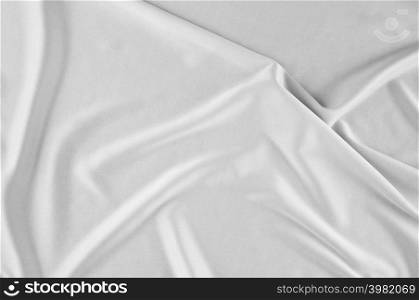 Smooth elegant white silk or satin luxury cloth can use as wedding background. Luxurious Christmas background or New Year background design. white fabric texture. Cloth Textile Surface. top view.. Smooth white silk or satin texture.