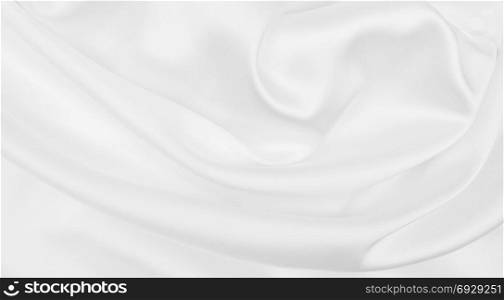 Smooth elegant white silk or satin luxury cloth texture can use as wedding background. Luxurious Christmas background or New Year background design