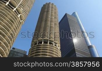 Smooth, low angle tracking shot, taken from a boat, as it rides down the Chicago River past towering skyscrapers and under a bridge