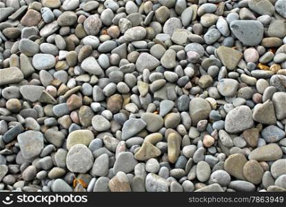 Smooth small pebbles and stones background.