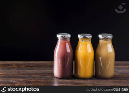 smoothie bottles wooden surface
