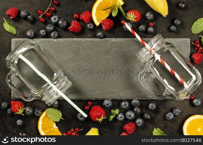 Smoothie ingredients and jars on dark rustic background