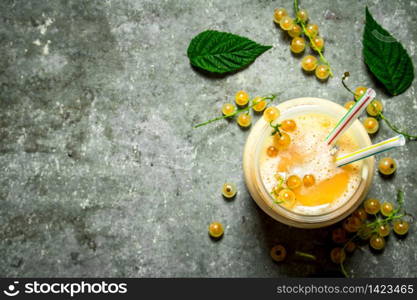 Smoothie made from white currants . On a stone background.. Smoothie made from white currants .