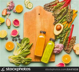 Smoothie making concept. Various healthy fresh fruits and vegetables with bottles on light mint table background with cutting board, top view , frame. Detox, dieting and clean eating