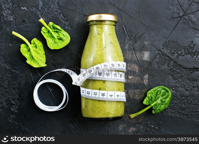 smoothie with spinach and kiwi in bottle