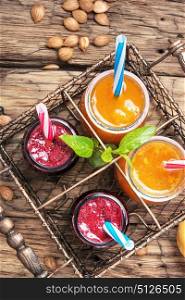 Smoothies with apricot and currant. Jars with apricot and berry smoothies in a stylish metal basket.Smoothie concept