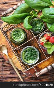 Smoothies with basil. Freshly blended basil and strawberry smoothie in glass jar