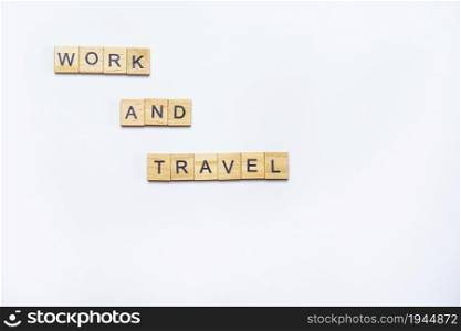 Smoothly laid out text with wooden cubes with the inscription work and travel, the concept of robots and travel abroad. Smoothly laid out text with wooden cubes with the inscription work and travel, the concept of robots and travel abroad.