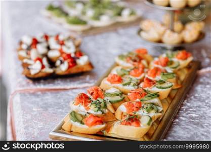 Snack. Bruschetta with salmon, avocado and microgreen sprouts on a wooden plate.. Snack. Bruschetta with salmon, avocado and microgreen sprouts on a wooden plate