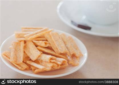 Snack on white plate with coffee cup, stock photo