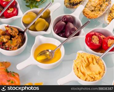 Snack set. Oktoberfest food frame concept. Variety of humus, olives, vegetables, cheese and sauces on white background. Top view