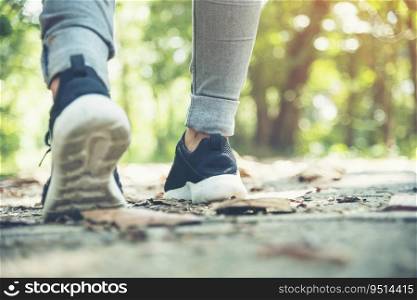 sneaker shoes young woman traveler sit down on summer park. Focus on sneaker shoes and jeans on pathway in forest park. active activity vacation on hike mountain walking way. Young traveler concept