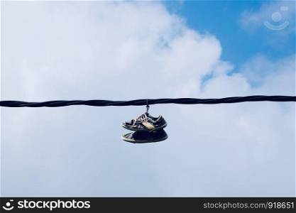 sneakers hanging in the cable in the street