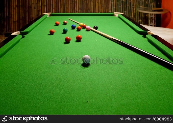 snooker balls and cue on snooker table