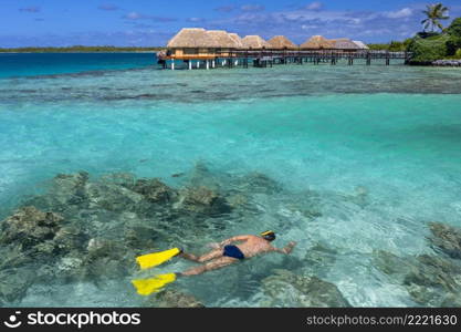 Snorkelling at a luxury resort on the tropical island of Mahini in French Polynesia in the South Pacific.