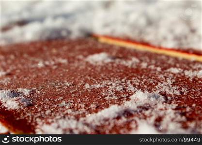 Snow closeup on a red wooden background