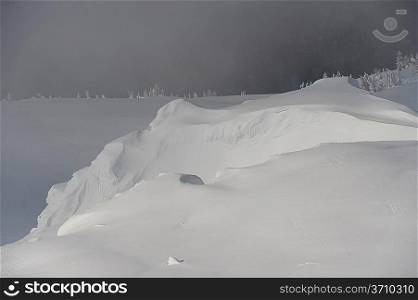 Snow covered mountain surrounded with fog, Whistler, British Columbia, Canada