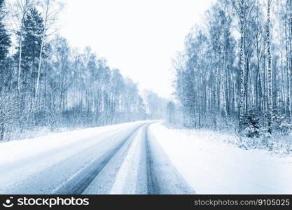 Snow-covered Open Road During A Snowstorm In Winter. Adverse Weather Conditions. Toned Filtered Photo. Snow-covered Open Road During A Snowstorm In Winter. Adverse Weather Conditions