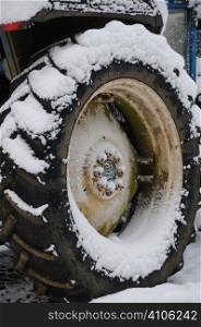 Snow covered tractor in woodland