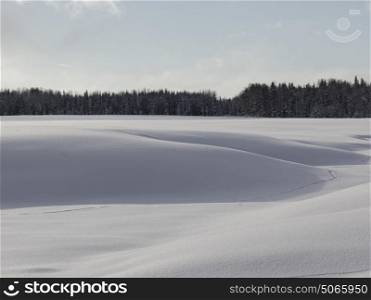 Snow Drifts on a frozen lake, Summit Lake, British Columbia Highway 97, British Columbia, Canada
