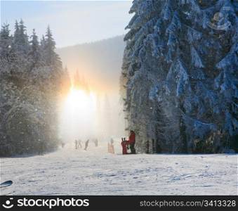 Snow dust dazzle shining on sunlight (winter mountain landscape with slope for skiing)