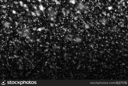 Snow falling on black background for winter season and christmas