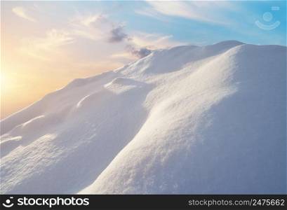 Snow hills at sunrise. Composition of nature.