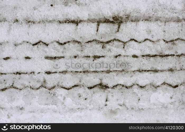 Snow macro detail of car weel footprint