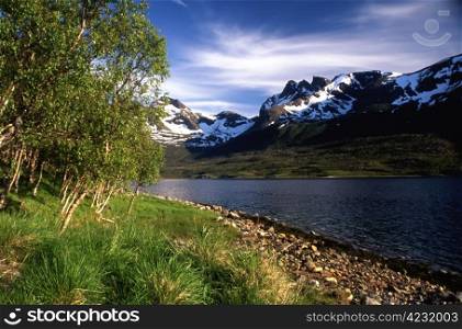 Snow mountain and lake in Norway in summer