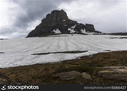 Snow on landscape with mountain in the background, Logan Pass, Glacier National Park, Glacier County, Montana, USA