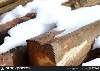 snow on wooden beams in winter wet wood