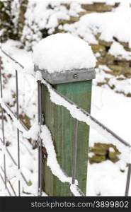 Snow on wooden pole and fence in winter season
