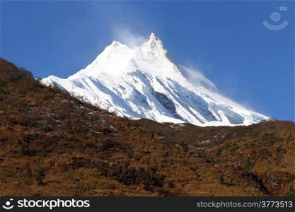 Snow peak of Manaslu and autumn forest in Nepal