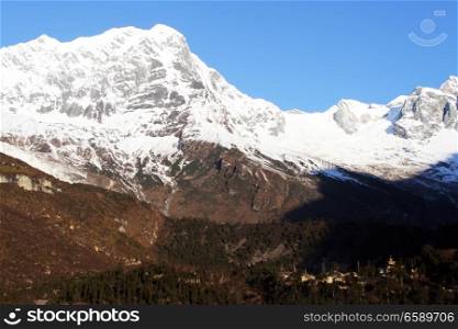 Snow peaks of Manaslu and monastery in Samagoon in Nepal