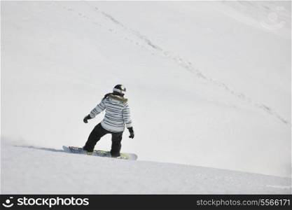 snowboard woman racing downhill slope and freeride on powder snow at winter season and sunny day
