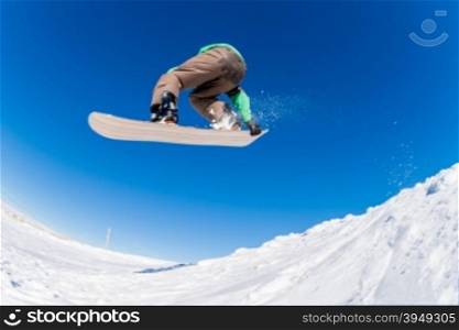 Snowboarder executing a radical jump against blue sky.