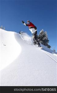 Snowboarder gliding down a slope
