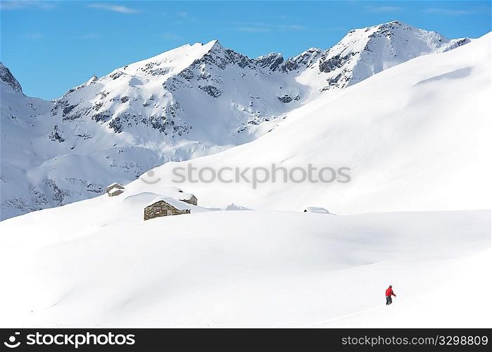 Snowboarder goes downhill over a snowy mountain landscape. Gressoney, Val d&acute;Aosta, Italy.