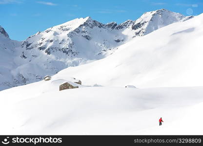 Snowboarder goes downhill over a snowy mountain landscape. Gressoney, Val d&acute;Aosta, Italy.