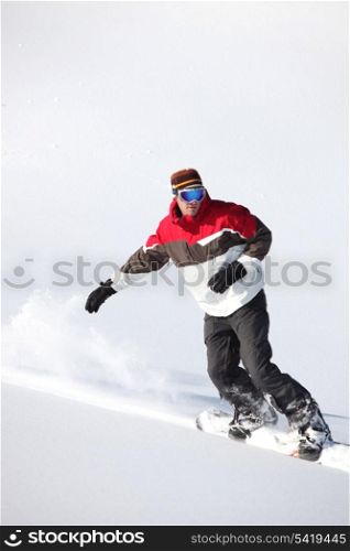 Snowboarder going downhill at high speed