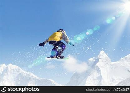 Snowboarder in jump. Man on snowboard jumping in sky. Summer vacation