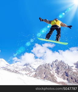 Snowboarder in jump. Man on snowboard jumping in sky. Summer vacation