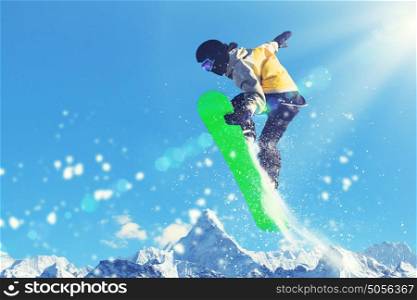 Snowboarder in jump. Man on snowboard jumping in sky. Summer vacation