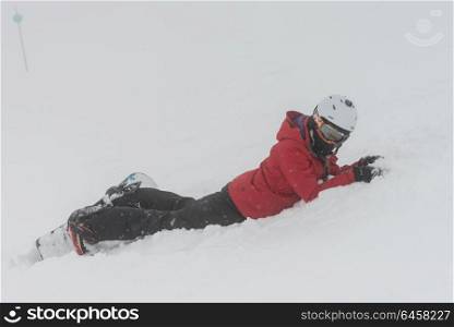 Snowboarder lying on snow , Whistler, British Columbia, Canada