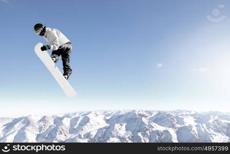 Snowboarder making high jump in clear blue sky. Snowboarding sport