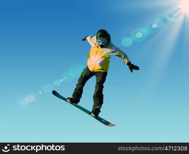 Snowboarder making jump high in clear sky. Snowboarding