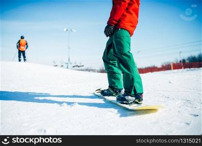 Snowboarder riding a snow hill. Winter extreme sport, active lifestyle. Snowboarding in mountains
